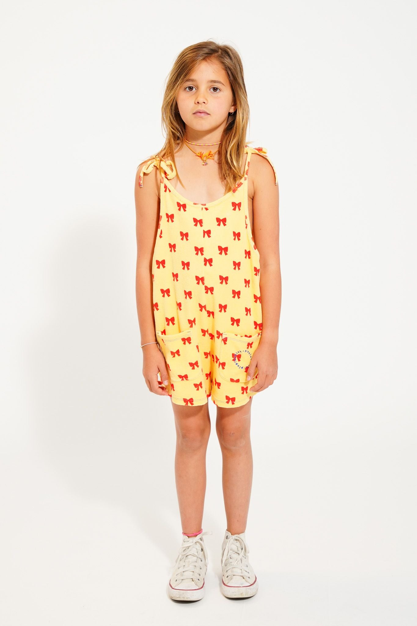 short jumpsuit w/ straps | yellow w/ red bows